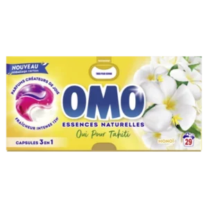 Boîte de lessive OMO Monoï 3 en 1 – 29 capsules, posée sur une surface propre avec un fond coloré
